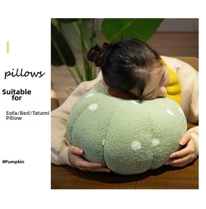 Close-up of green polka dot pumpkin pillow with soft textured sherpa fabric detail