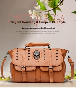 Close-up of vintage brown lychee leather handbag with punk skull and metal rivets detail