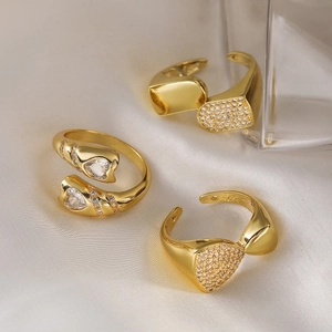Three 18K gold-plated irregular geometric adjustable rings with zircons on beige silk