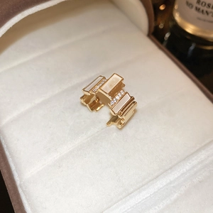 Close-up of gold-plated zircon ring with white inlay inside a luxury jewelry box