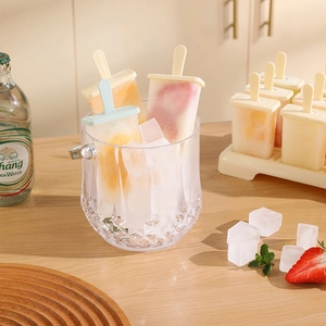 Silicone popsicle mold set with ice bucket and homemade fruit ice pops on kitchen counter