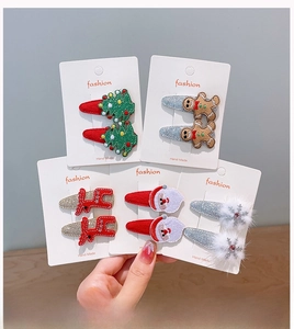 Detail of Christmas hair clips featuring reindeer and Santa motifs on display cards