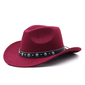 Detail of wine red cowboy hat featuring turquoise beads and silver studs on black band