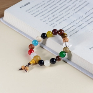Macro view of multi-material Buddhist beads bracelet on an open vintage book page