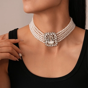 Macro shot of multi-layer baroque pearl necklace with a vintage crystal pendant