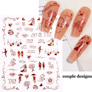 Macro view of 3D wedding nail stickers with red metallic hearts and rose motifs