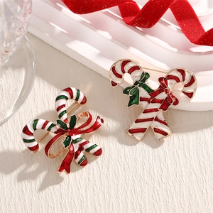 Christmas candy cane enamel brooches with festive red and white stripes and holly leaf detail