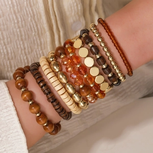 Bohemian multilayer beaded bracelet set with wood and gold beads on model wrist