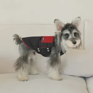 Detail of windproof black and red pet vest with metal buttons and stitched label