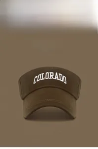 Detail of COLO embroidery on a cotton visor cap showing multiple color options