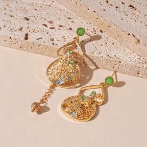 Asymmetric gold gourd earrings with green beads and hollow filigree tassels