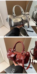 Detail of retro saddle bag showing square pockets, dual handles and wax finish texture