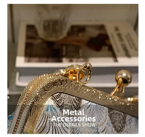 Macro shot of gold-tone floral engraved metal hardware on vintage brocade handbag