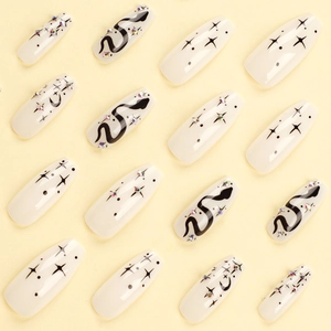 Gothic starburst press-on nails with snake pattern and rhinestones on long coffin shape