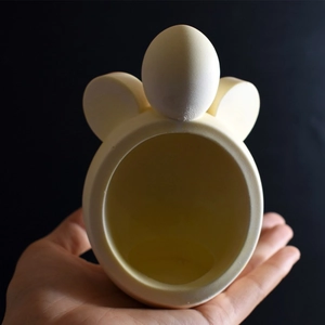 Close-up of a white mouse-shaped silicone mold for DIY aromatherapy candle holders