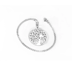 Macro detail of silver owl and tree of life pendant on a fine stainless steel chain