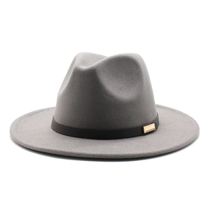 Detailed texture of grey felt fedora with black leather band and gold metal buckle