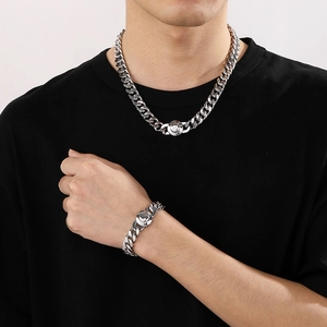 Close-up of a 11mm silver titanium steel Cuban chain necklace and bracelet set for men
