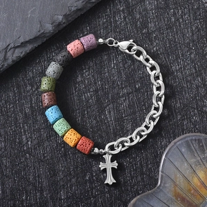 Detail of cross pendant bracelet with colorful volcanic stone beads and silver chain link