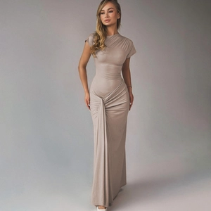 Detailed view of the elegant ruching and gathered waist on a slim-fit knit maxi dress