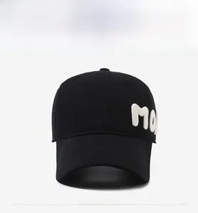 Detailed side view of black cotton baseball cap with white 3D letter embroidery