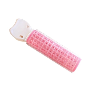 Pink hair root volume clip and roller for styling bangs and natural fluffy hairstyles