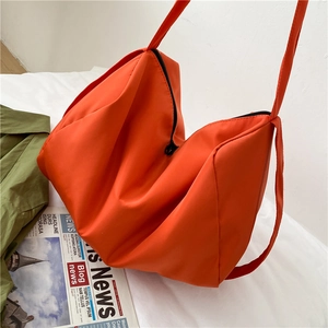 Large orange oxford tote bag for sports and fitness shown in a minimal lifestyle setting