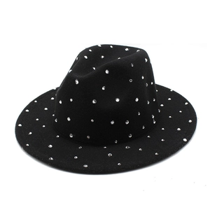Close-up of black felt jazz hat with sparkling silver rhinestones on a white background