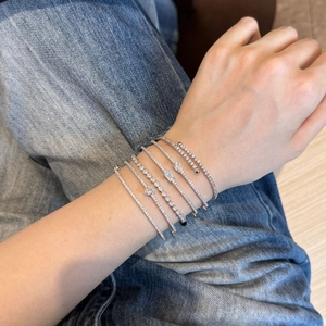 Detail of silver S925 sterling silver bracelets with geometric zircons worn on wrist