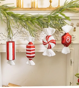 Detailed view of red and white striped Christmas candy ornaments on a festive mantel