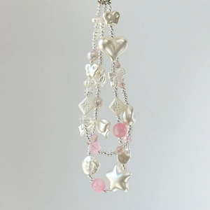Detailed view of colorful acrylic beads with star and butterfly shapes on a beaded phone strap