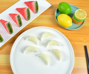 Miniature dumplings set with transparent texture on a white plate for play kitchens