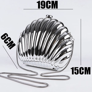 Silver shell-shaped acrylic evening clutch showing dimensions of 19cm by 15cm