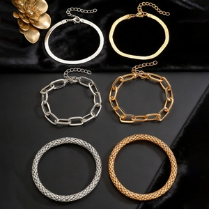 Close-up of bohemian style gold and silver alloy bracelet set with various textured links
