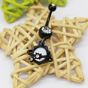 Macro detail of black moon belly ring with sparkling zircon and opal planet charm on star