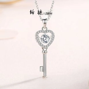 Macro shot of S925 silver heart key pendant with dancing zircon and pavé diamonds