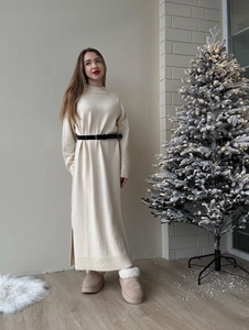 Loose-fit cream knit maxi dress with side slit and belt in cozy Christmas setting