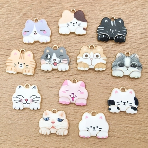 Flat lay detail of twelve assorted enamel cat alloy charms for DIY jewelry making