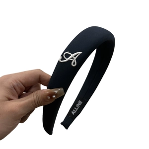 Plush black velvet headband with white embroidered letter A and soft fabric finish