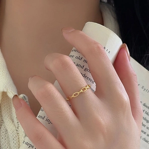 Close-up of minimalist gold-plated 925 sterling silver chain ring worn on hand