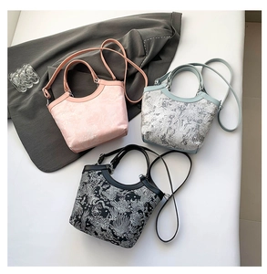 Detailed view of jacquard floral textures on pink blue and black bucket bags