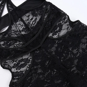 Detailed close-up of intricate black floral lace pattern on a sheer mesh bodysuit