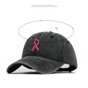 Detailed view of pink ribbon embroidery on charcoal washed cotton baseball cap with sizing