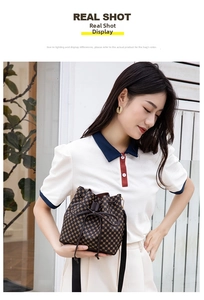 Detail of brown drawstring bucket bag with geometric prints and bow accent in a lifestyle setting