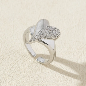 Detail of silver heart ring featuring asymmetrical zircon pavé and adjustable band