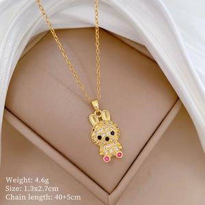 Close-up of golden bunny necklace with pavé crystals, red eyes and pink stone details