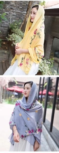 Detailed view of floral embroidery on yellow and gray lightweight shawls for women