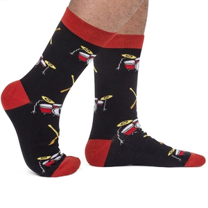 Close-up of black cotton socks featuring red accents and graphic drum set patterns