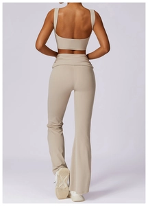 Back view of high waisted flare yoga pants and racerback sports bra in beige knit