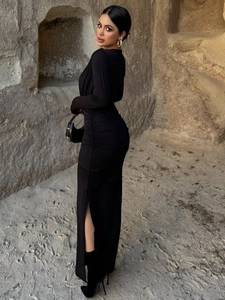 Slim fit long sleeve black dress with ruched waist and side slit details